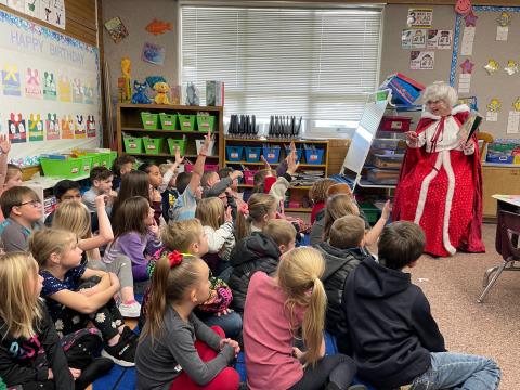 Mrs Claus reading to students